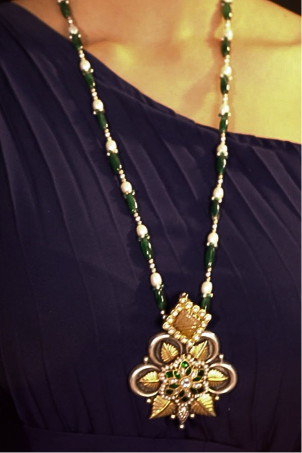 Decorative necklace with a gold pendant 