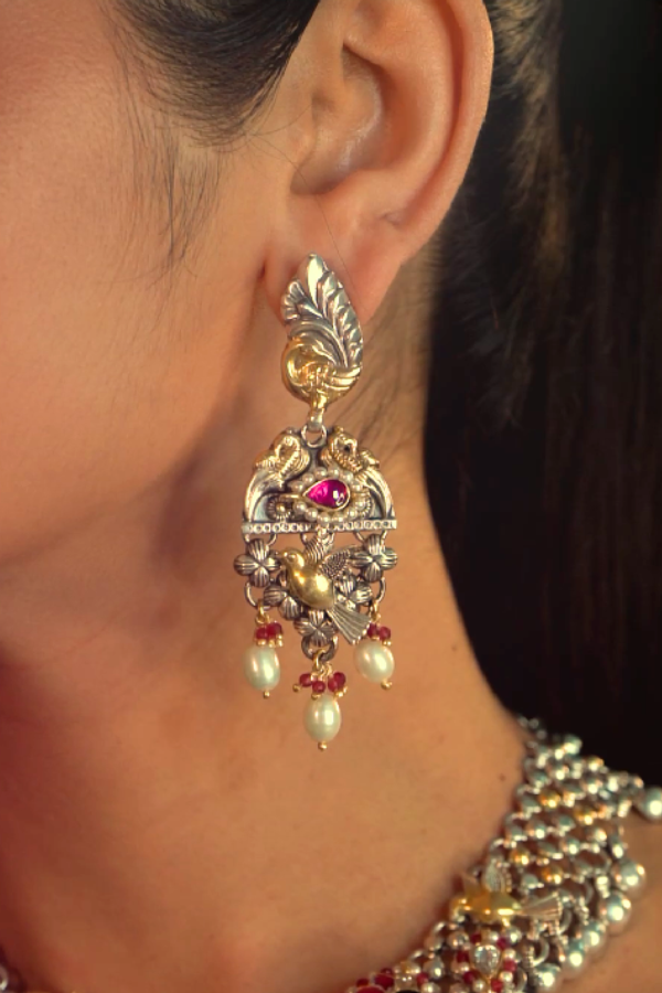 ornate earring with a gemstone.