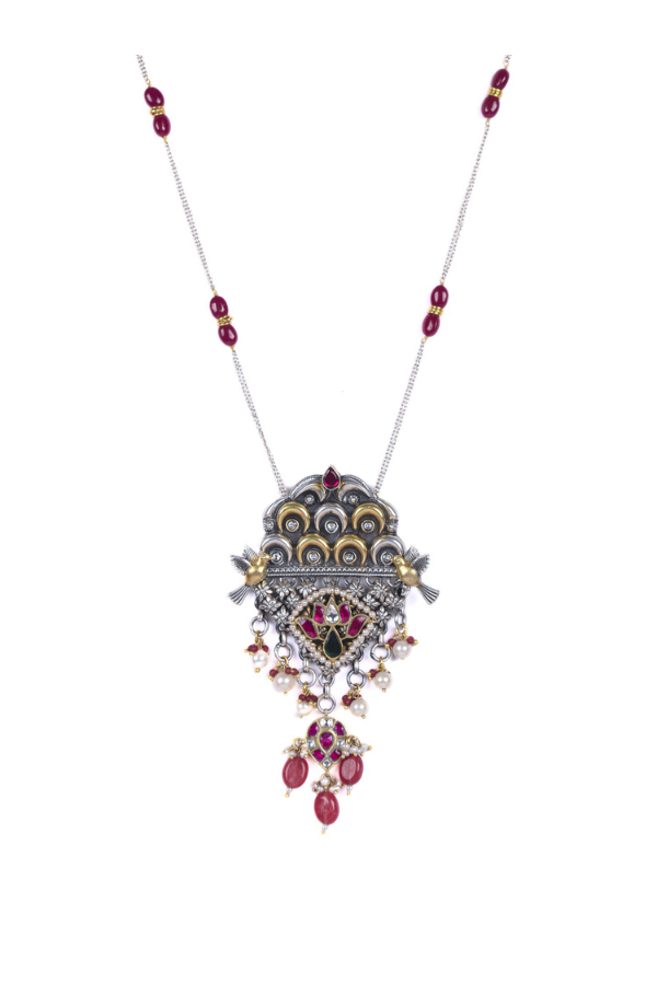 Elegant necklace with a decorative pendant featuring red gemstones