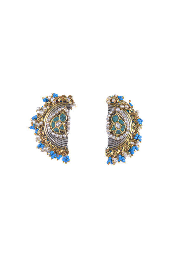Pair of ornate earrings with blue accents