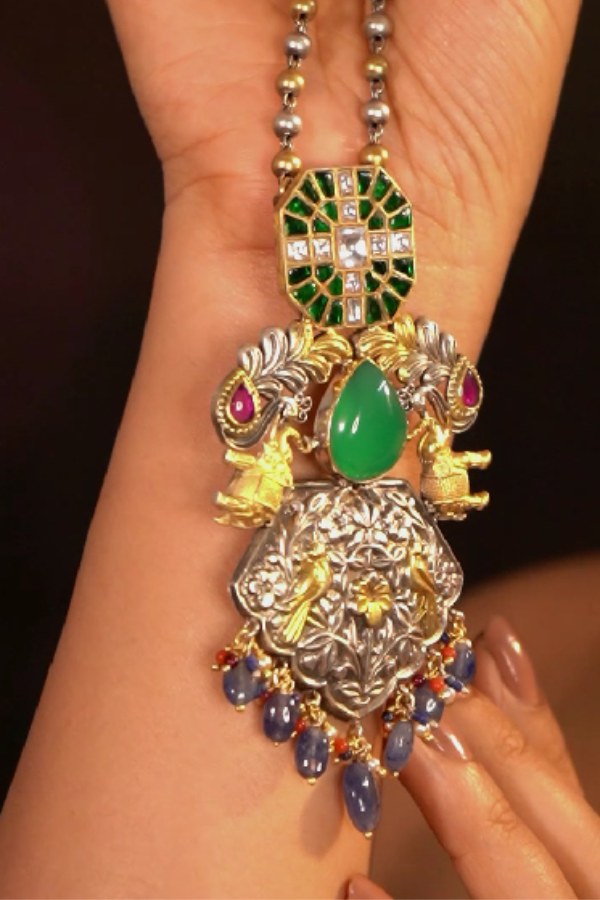 Ornate necklace with green gemstone and gold accents