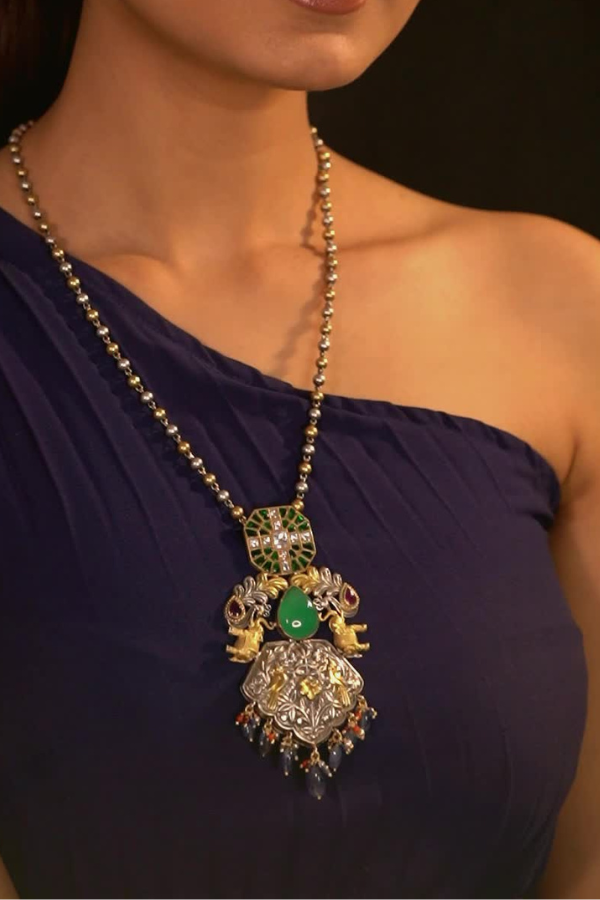 decorative necklace with a green gemstone