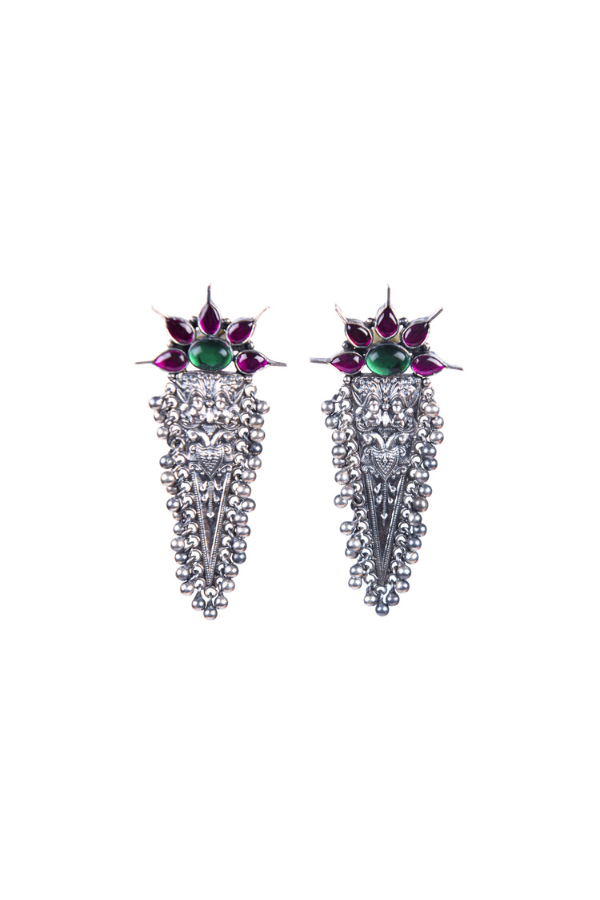 Pair of ornate earrings with gemstones 