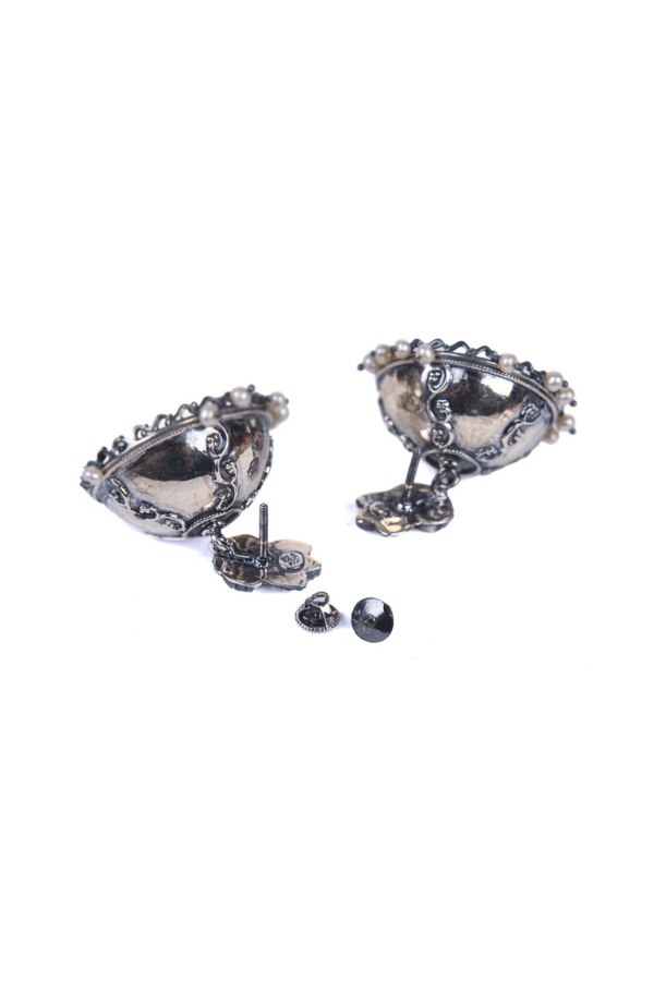 Pair of silver earrings with intricate designs