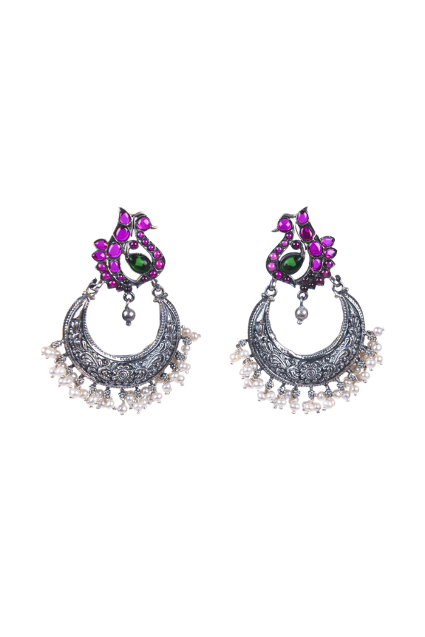 Pair of ornate earrings with ruby gemstones