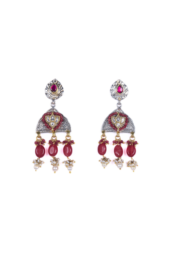 Pair of ornate earrings with red gemstones