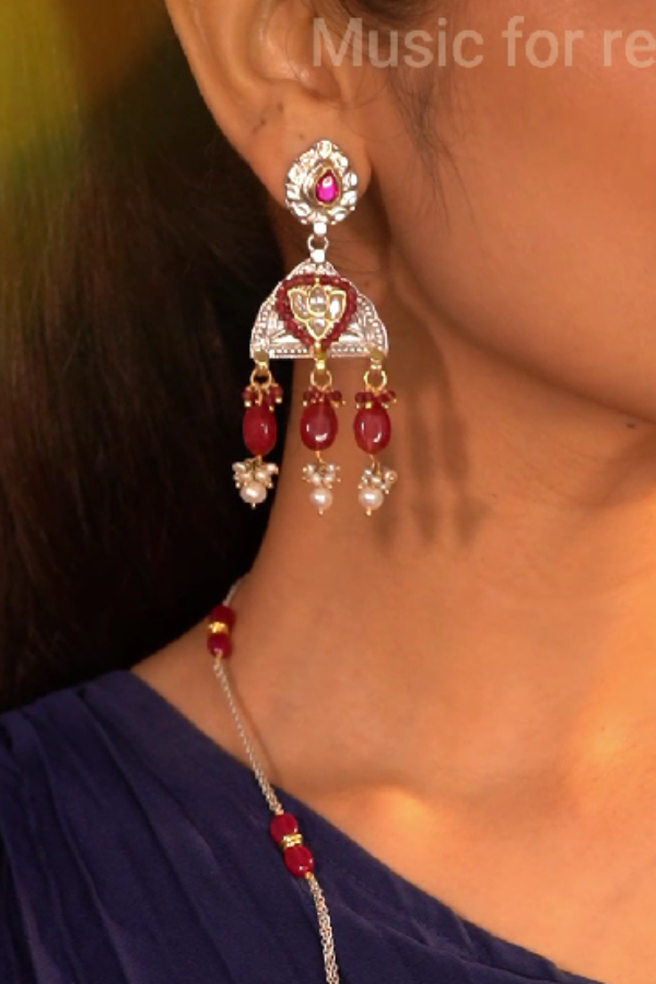 ornate earrings with red stones.