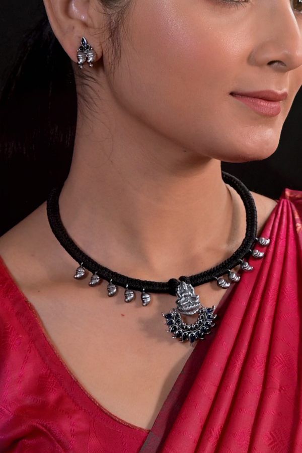 Black necklace with silver pendants and earrings.