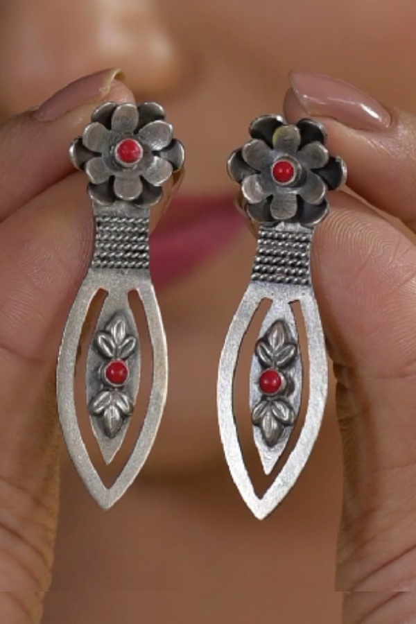 Silver floral earrings with red stones