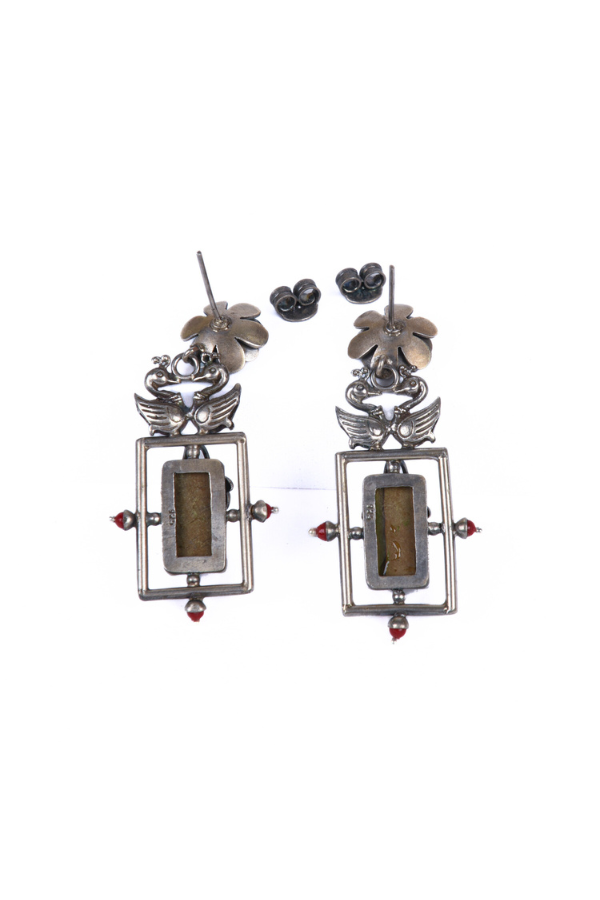 Pair of silver earrings with rectangular designs and floral elements