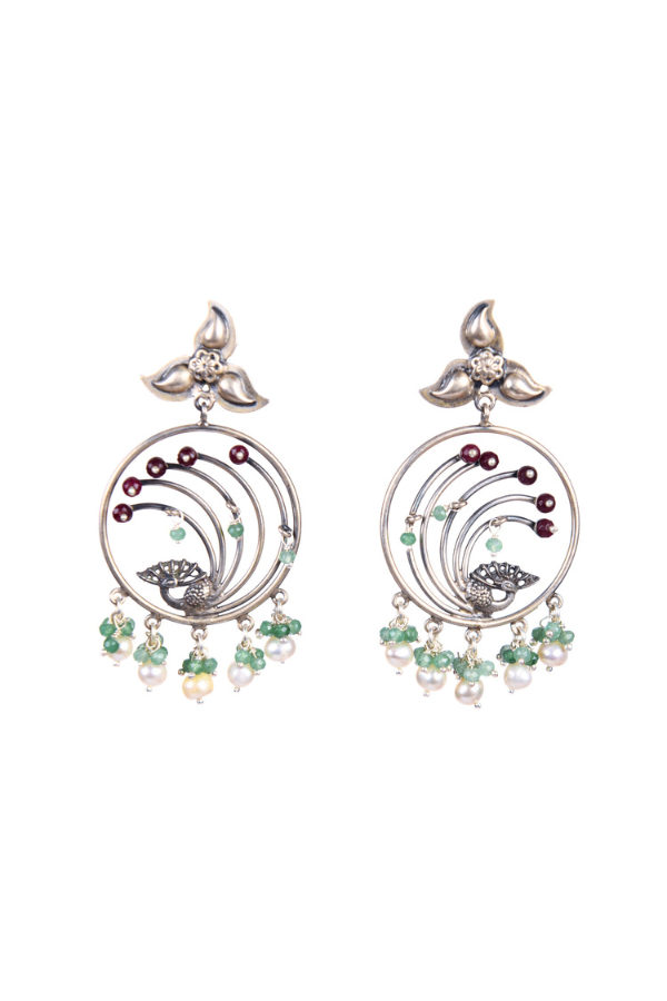 Pair of silver earrings with green and red gemstones.