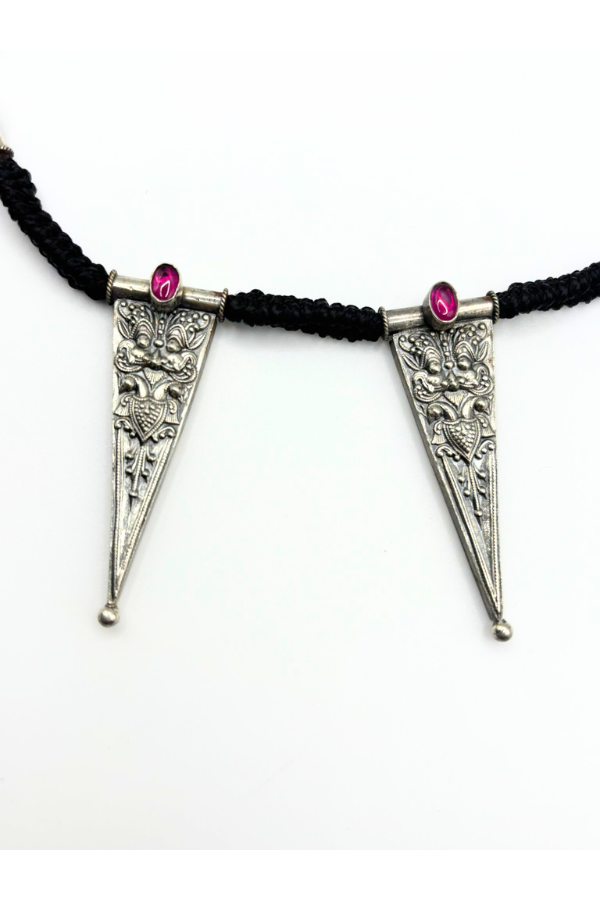 Necklace with triangular silver pendants and pink stones on a black cord