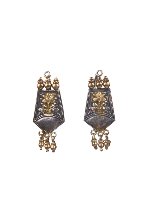 Pair of ornate earrings with intricate designs 