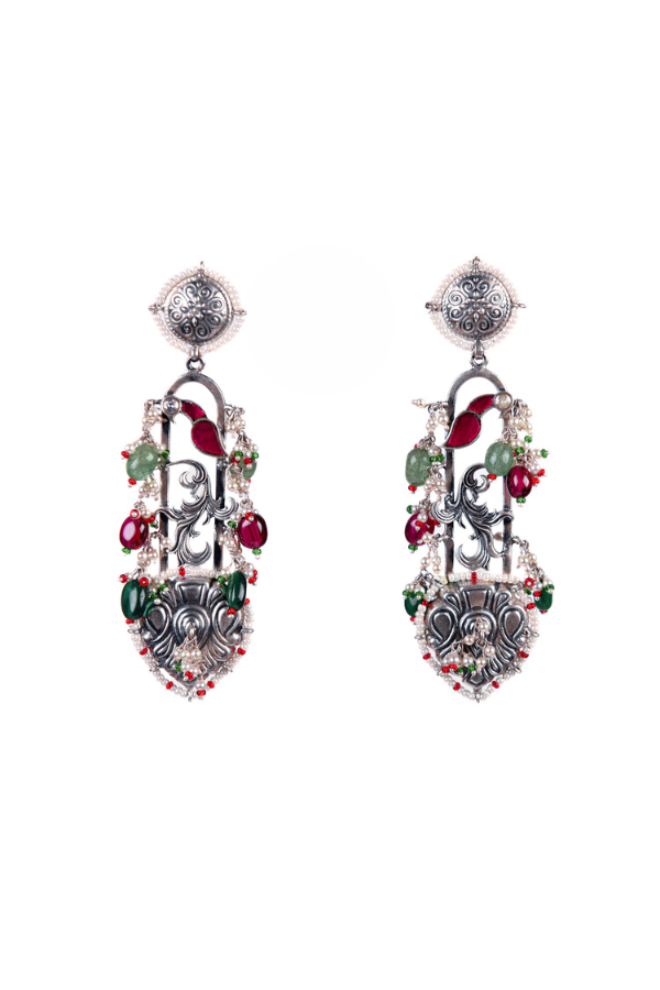 Pair of ornate earrings with gemstones