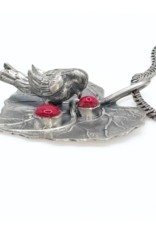 Silver bird and leaf design on a white background