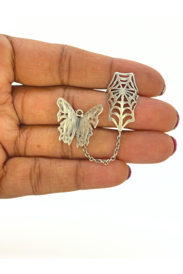 Butterfly and spider web-shaped silver stud earring.