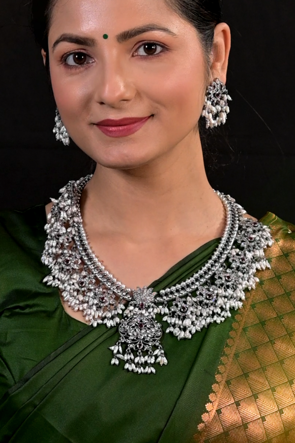 silver necklace and earrings