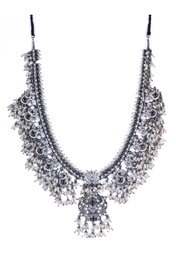 Elegant silver necklace with floral designs and gemstones