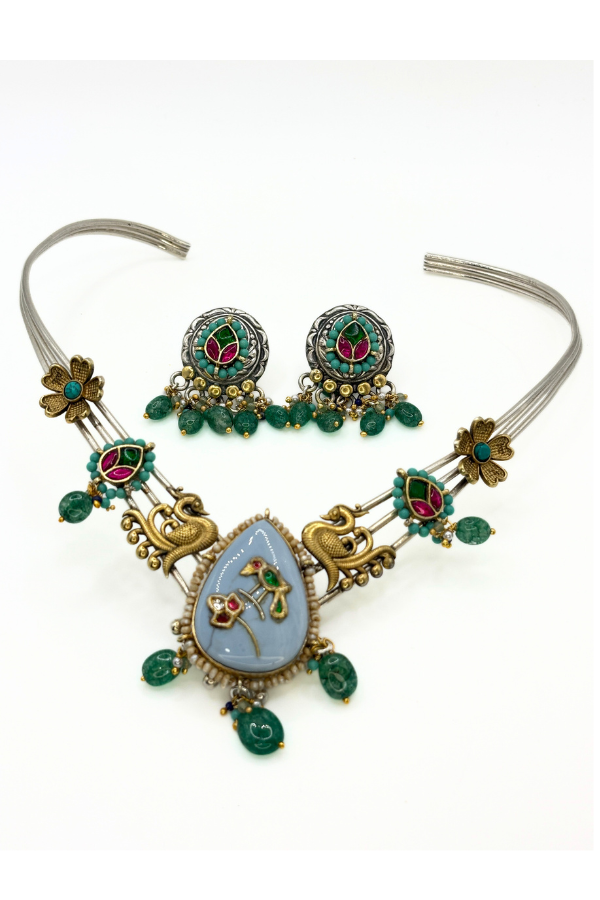 Ornate necklace with emerald green and red accents