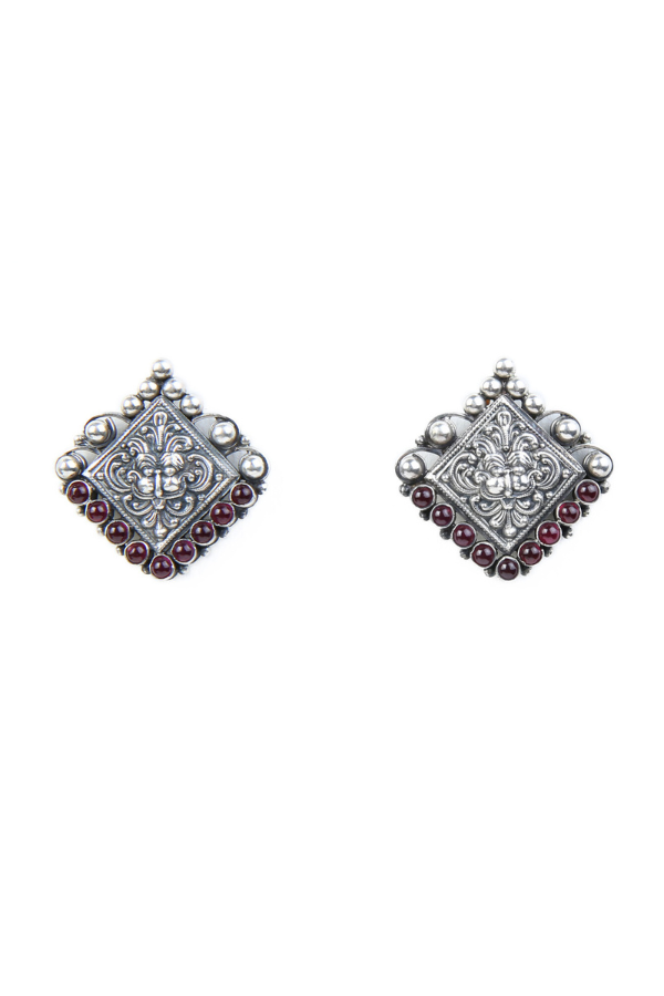 Pair of silver earrings with red gemstones
