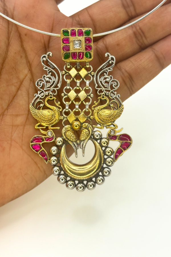 Ornate gold and silver necklace with peacock design
