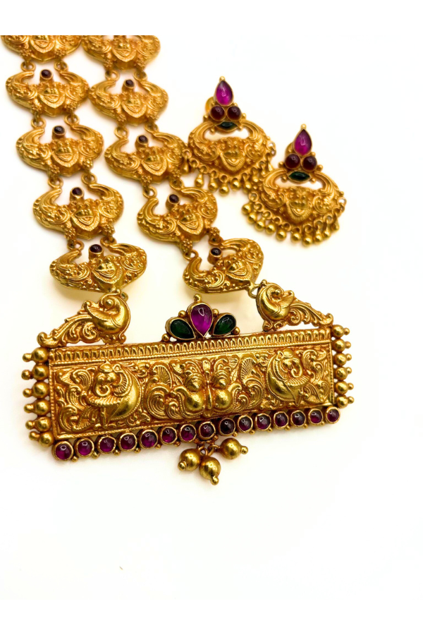 Gold necklace with red and green gemstones