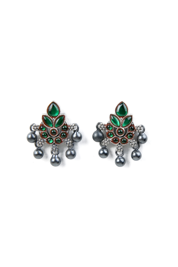 Pair of ornate earrings with green gemstones and dangling