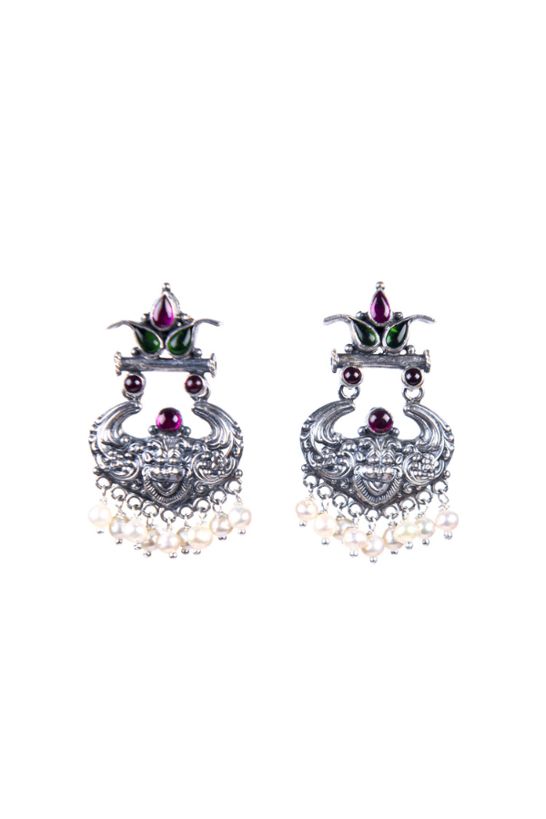 Pair of ornate earrings with intricate designs and pearl-like beads 