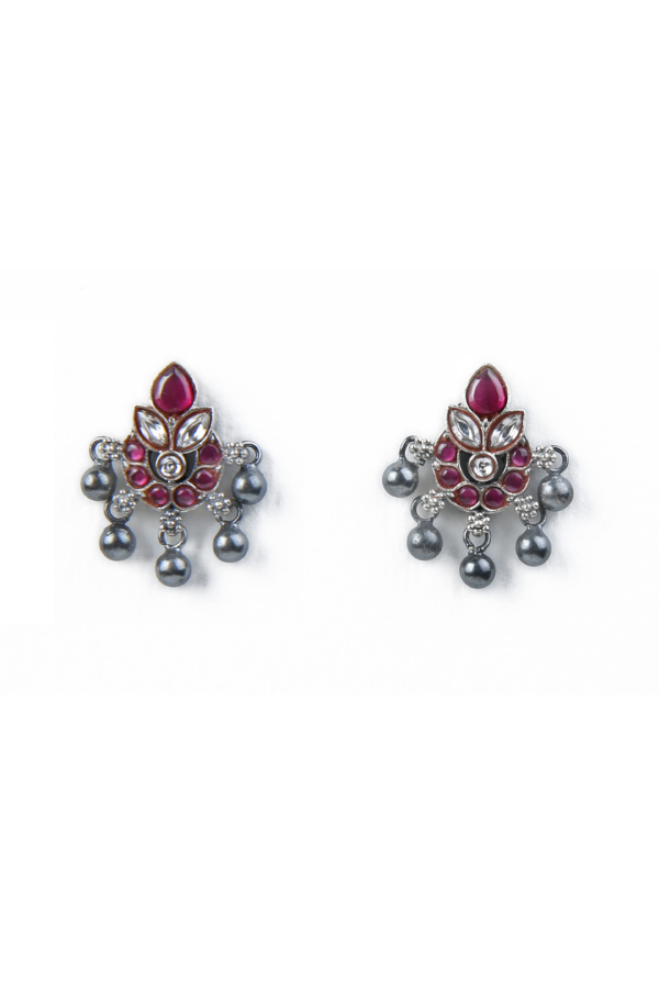 Pair of decorative earrings with red ruby gemstones 