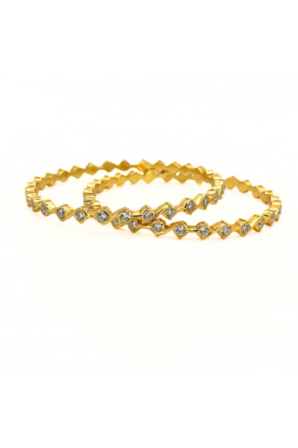 Two gold bangles with diamond-like stones 