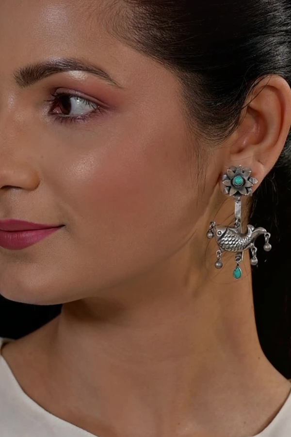decorative earring with turquoise stones.